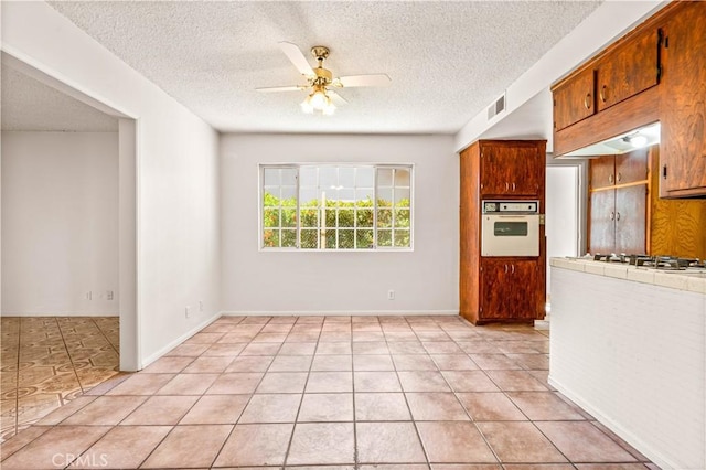 43236 W 20th St W, Lancaster, CA 93534 - kitchen with white appliances, tile counters, ceiling fan, a textured ceiling, and light tile patterned flooring