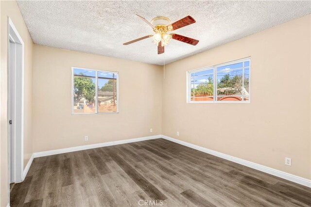 43236 W 20th St W, Lancaster, CA 93534 - unfurnished bedroom featuring wood finished floors, a textured ceiling, multiple windows, and a ceiling fan