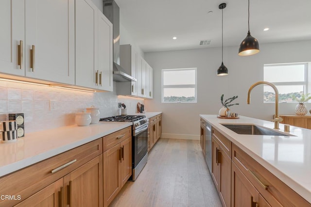 3874 W Point Dr, Los Angeles, CA 90065 - kitchen with appliances with stainless steel finishes, backsplash, hanging light fixtures, light countertops, and light wood-type flooring