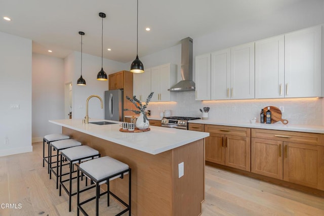 3874 W Point Dr, Los Angeles, CA 90065 - kitchen featuring wall chimney range hood, stainless steel appliances, decorative backsplash, light wood-style flooring, and recessed lighting