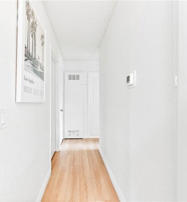 1442 Brett Pl Unit 31, San Pedro, CA 90732 - hallway with light wood-style flooring and a textured ceiling