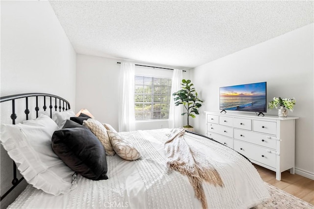 1442 Brett Pl Unit 31, San Pedro, CA 90732 - bedroom with light wood-type flooring and a textured ceiling