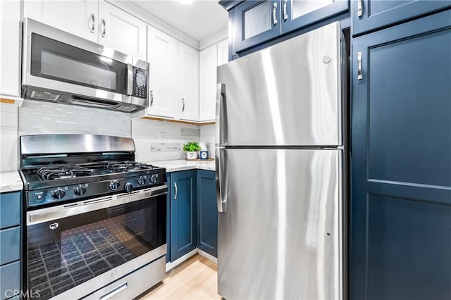 1442 Brett Pl Unit 31, San Pedro, CA 90732 - kitchen featuring stainless steel appliances, blue cabinets, and light stone countertops