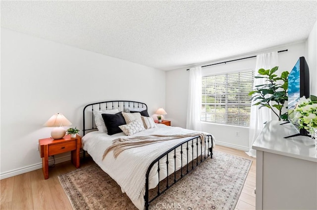 1442 Brett Pl Unit 31, San Pedro, CA 90732 - bedroom featuring light wood-style flooring and a textured ceiling