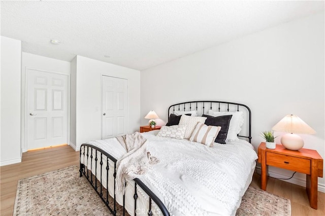 1442 Brett Pl Unit 31, San Pedro, CA 90732 - bedroom featuring light wood-style flooring and a textured ceiling