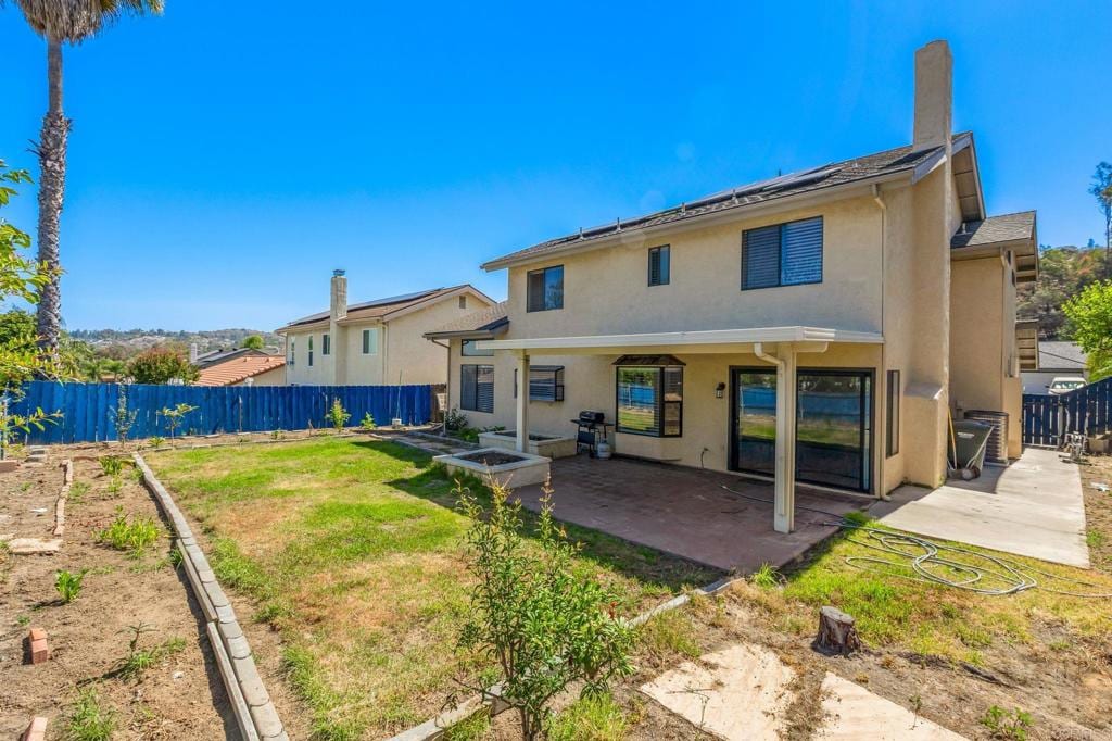 2022 Seca St, El Cajon, CA 92019 - back of property featuring a patio area, stucco siding, a fenced backyard, and a chimney