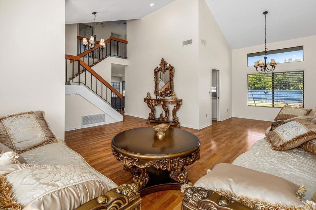 2022 Seca St, El Cajon, CA 92019 - living area with a chandelier, high vaulted ceiling, wood finished floors, and stairs