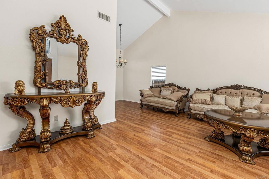 2022 Seca St, El Cajon, CA 92019 - living area with beamed ceiling, a chandelier, wood finished floors, and high vaulted ceiling