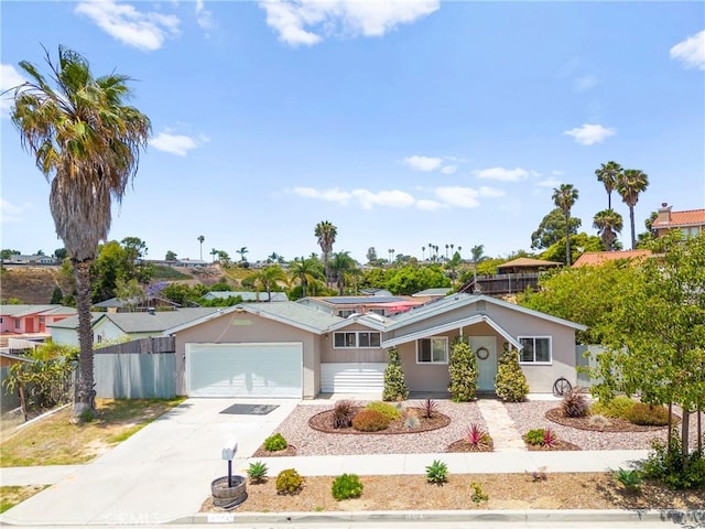 4054 Lewis St, Oceanside, CA 92056 - ranch-style home featuring concrete driveway, an attached garage, stucco siding, and roof mounted solar panels