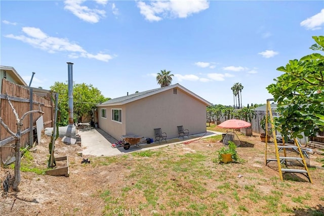 4054 Lewis St, Oceanside, CA 92056 - back of house with stucco siding, a fenced backyard, and a patio area