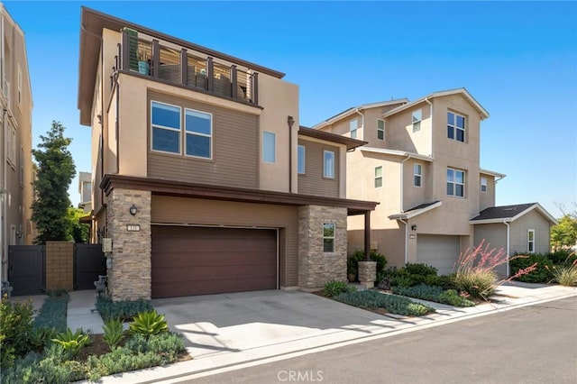 131 Spiral, Irvine, CA 92618 - view of front of property with a garage, stucco siding, stone siding, and concrete driveway