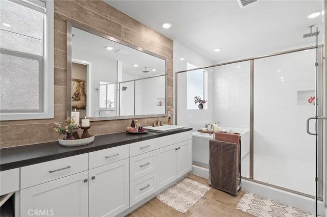 131 Spiral, Irvine, CA 92618 - full bathroom with a stall shower, double vanity, tile walls, backsplash, and wood finished floors