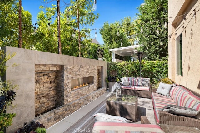 131 Spiral, Irvine, CA 92618 - view of patio with an outdoor living space with a fireplace