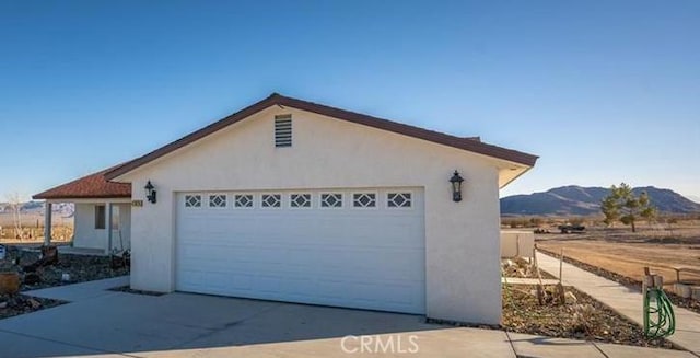 61975 La Brisa Dr, Joshua Tree, CA 92252 - garage with a mountain view and concrete driveway