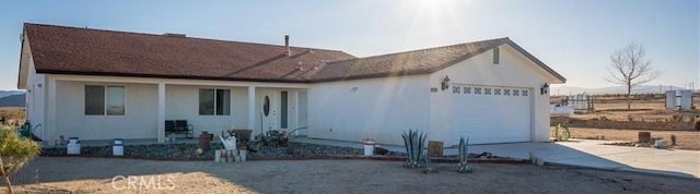 61975 La Brisa Dr, Joshua Tree, CA 92252 - view of front of property featuring an attached garage, driveway, and a porch