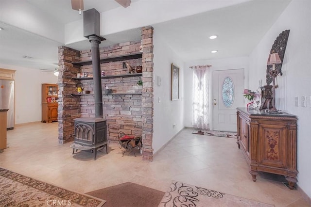 61975 La Brisa Dr, Joshua Tree, CA 92252 - entrance foyer with ceiling fan, a wood stove, light tile patterned floors, and recessed lighting