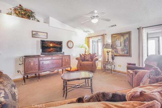 61975 La Brisa Dr, Joshua Tree, CA 92252 - carpeted living room with a textured ceiling, vaulted ceiling, and ceiling fan