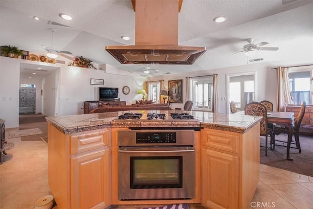 61975 La Brisa Dr, Joshua Tree, CA 92252 - kitchen with appliances with stainless steel finishes, island range hood, ceiling fan, vaulted ceiling, and a textured ceiling