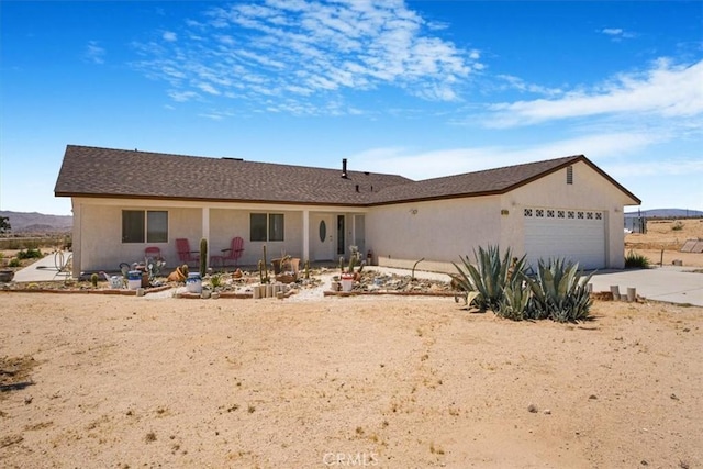 61975 La Brisa Dr, Joshua Tree, CA 92252 - ranch-style home with a garage, concrete driveway, and stucco siding