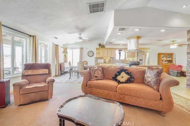 61975 La Brisa Dr, Joshua Tree, CA 92252 - living room with ceiling fan, vaulted ceiling, light colored carpet, and a textured ceiling