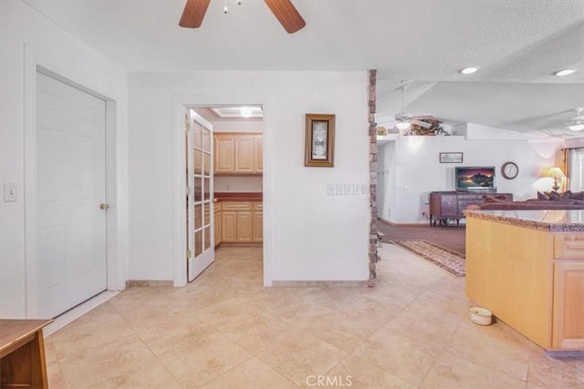 61975 La Brisa Dr, Joshua Tree, CA 92252 - interior space with a ceiling fan, light brown cabinets, lofted ceiling, open floor plan, and a textured ceiling