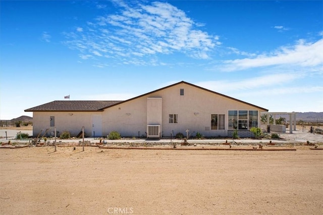 61975 La Brisa Dr, Joshua Tree, CA 92252 - back of property featuring stucco siding