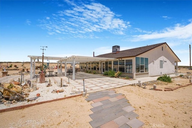 61975 La Brisa Dr, Joshua Tree, CA 92252 - rear view of house with a pergola and a patio area