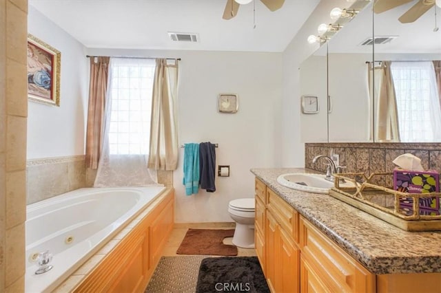 61975 La Brisa Dr, Joshua Tree, CA 92252 - bathroom with ceiling fan, plenty of natural light, and a tub with jets