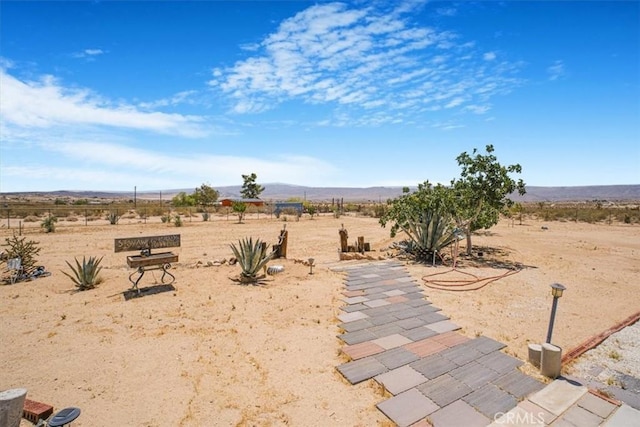 61975 La Brisa Dr, Joshua Tree, CA 92252 - view of yard featuring view of desert landscape, a mountain view, and a view of countryside