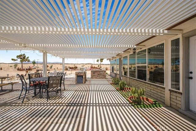 61975 La Brisa Dr, Joshua Tree, CA 92252 - view of patio / terrace featuring a pergola, outdoor dining space, and a mountain view