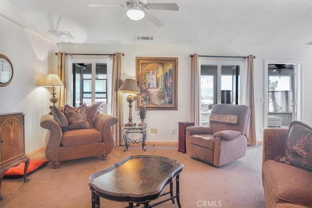 61975 La Brisa Dr, Joshua Tree, CA 92252 - living room featuring carpet, a ceiling fan, plenty of natural light, and a textured ceiling