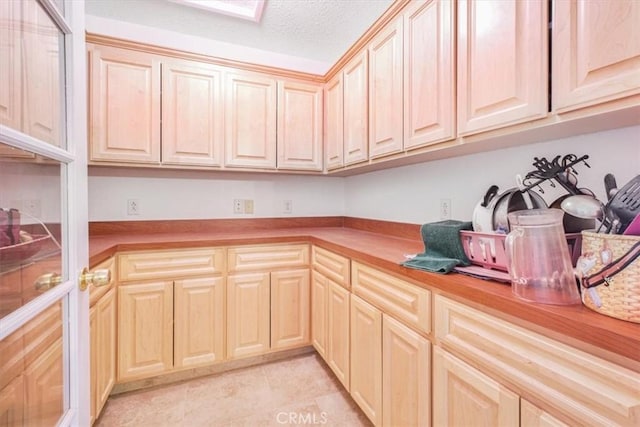 61975 La Brisa Dr, Joshua Tree, CA 92252 - kitchen with light countertops, a textured ceiling, and light brown cabinets