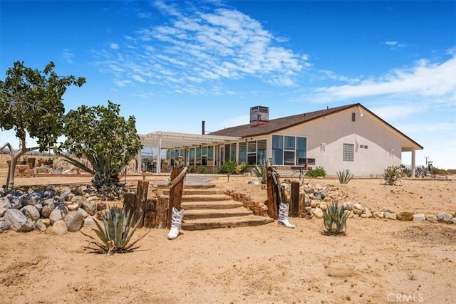 61975 La Brisa Dr, Joshua Tree, CA 92252 - rear view of property with a chimney