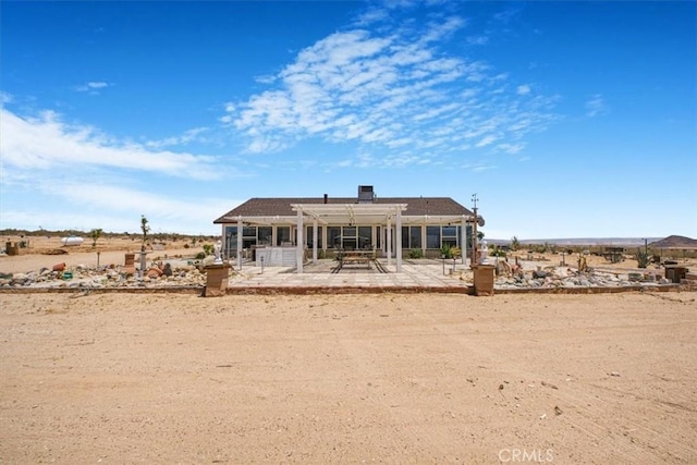 61975 La Brisa Dr, Joshua Tree, CA 92252 - rear view of property featuring a patio area and a pergola