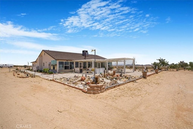 61975 La Brisa Dr, Joshua Tree, CA 92252 - rear view of house with a patio and a sunroom