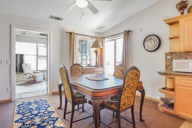 61975 La Brisa Dr, Joshua Tree, CA 92252 - dining area with lofted ceiling, a ceiling fan, light carpet, and a textured ceiling