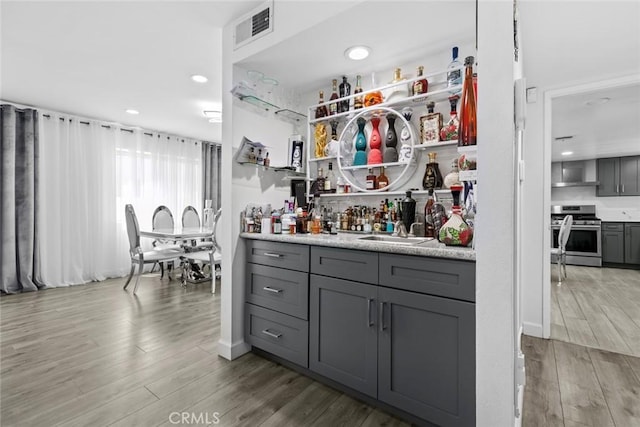8801 Cedros Ave Unit 7, Panorama City, CA 91402 - indoor dry bar with stainless steel stove, wood finished floors, and recessed lighting