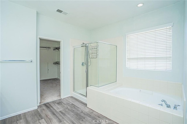 11935 Silver, Jurupa Valley, CA 91752 - bathroom featuring a garden tub, a stall shower, wood finished floors, and a spacious closet