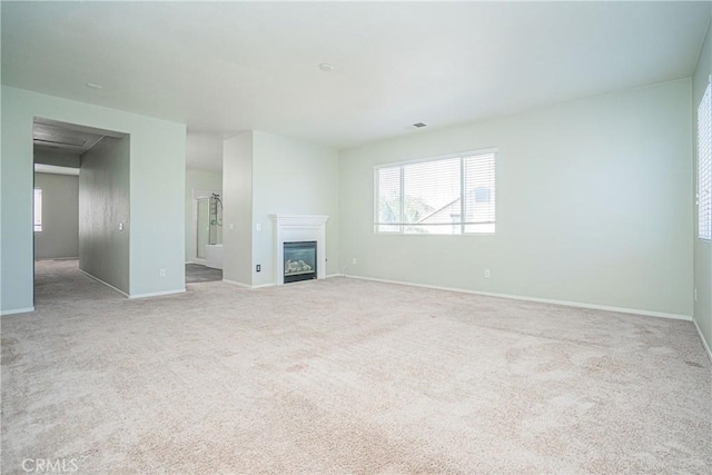 11935 Silver, Jurupa Valley, CA 91752 - unfurnished living room featuring plenty of natural light, carpet, and a glass covered fireplace
