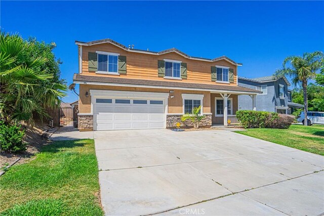 11935 Silver, Jurupa Valley, CA 91752 - view of front of house with stone siding, a garage, driveway, and covered porch