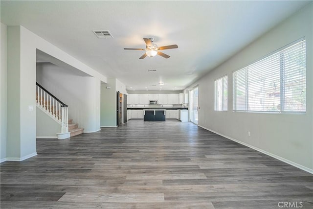 11935 Silver, Jurupa Valley, CA 91752 - unfurnished living room featuring a ceiling fan, stairs, and dark wood-style floors