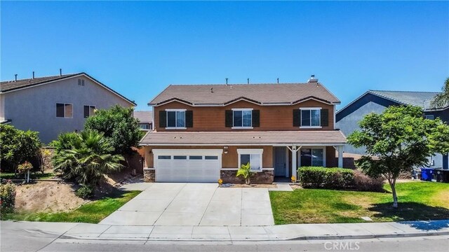 11935 Silver, Jurupa Valley, CA 91752 - traditional home with a garage, a front yard, driveway, a porch, and stone siding