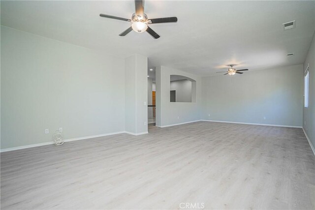 11935 Silver, Jurupa Valley, CA 91752 - unfurnished living room featuring ceiling fan, light wood-type flooring, and arched walkways