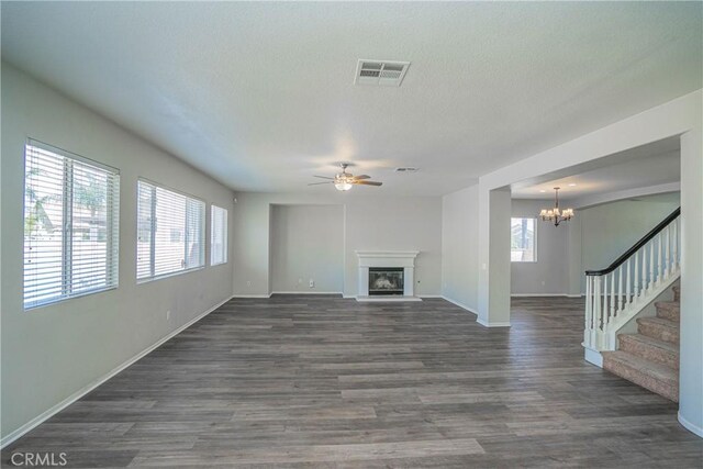11935 Silver, Jurupa Valley, CA 91752 - unfurnished living room with a ceiling fan, a chandelier, dark wood-type flooring, a glass covered fireplace, and stairway