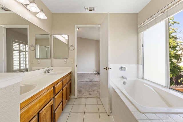 8041 Lomand Ct, Sacramento, CA 95828 - full bathroom with double vanity, a garden tub, healthy amount of natural light, and tile patterned flooring