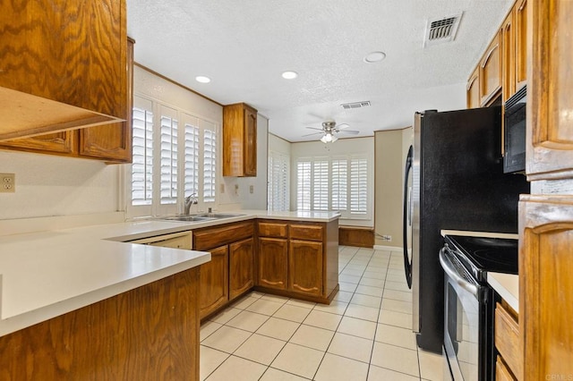 8041 Lomand Ct, Sacramento, CA 95828 - kitchen featuring black appliances, ceiling fan, a textured ceiling, a peninsula, and brown cabinets