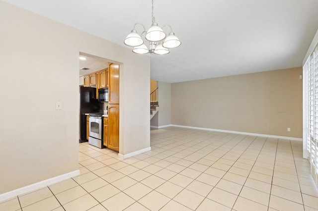 8041 Lomand Ct, Sacramento, CA 95828 - kitchen featuring electric range, black microwave, a chandelier, brown cabinets, and decorative light fixtures