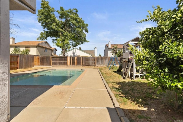 8041 Lomand Ct, Sacramento, CA 95828 - view of swimming pool featuring a playground, a fenced backyard, and a patio