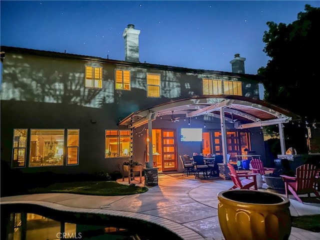 1073 Peter Christian Cir, Corona, CA 92881 - back of house at twilight with a patio and stucco siding