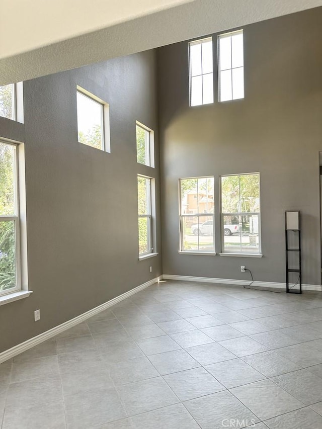 1073 Peter Christian Cir, Corona, CA 92881 - tiled empty room featuring a high ceiling and baseboards